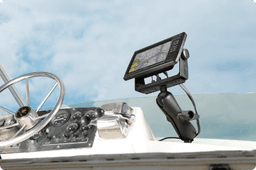 Marine chartplotter displaying detailed nautical map secured in RAM® Mount articulating arm system installed on boat helm, positioned for hands-free navigation with steering wheel and marine controls visible.
